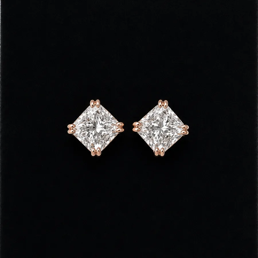 A pair of cushion-cut diamond stud earrings in rose gold
